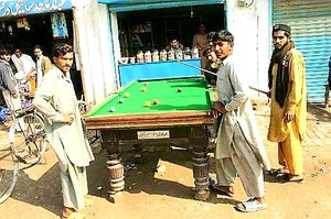 Australian Cricket Tours - Boys Playing Snooker On A Road-side Snooker Table In Multan, Pakistan