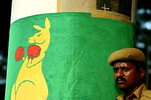 Australian Cricket Tours - An Indian Police Officer Leans Against The Boxing Kangaroo Flag Wrapped Around A Pillar In Chepauk Stadium, Chennai, India
